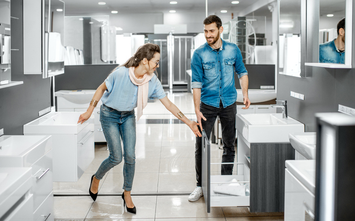 A man and a woman in a bathroom showroom
